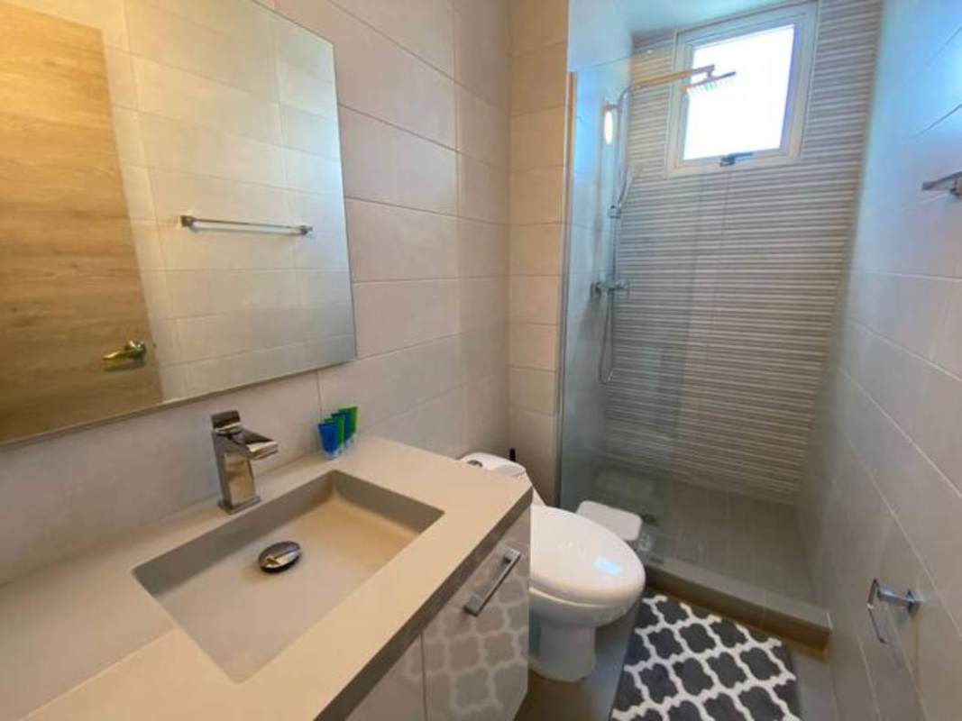 Modern bathroom with glass enclosed shower, mirror and window PH Signature Point Panama