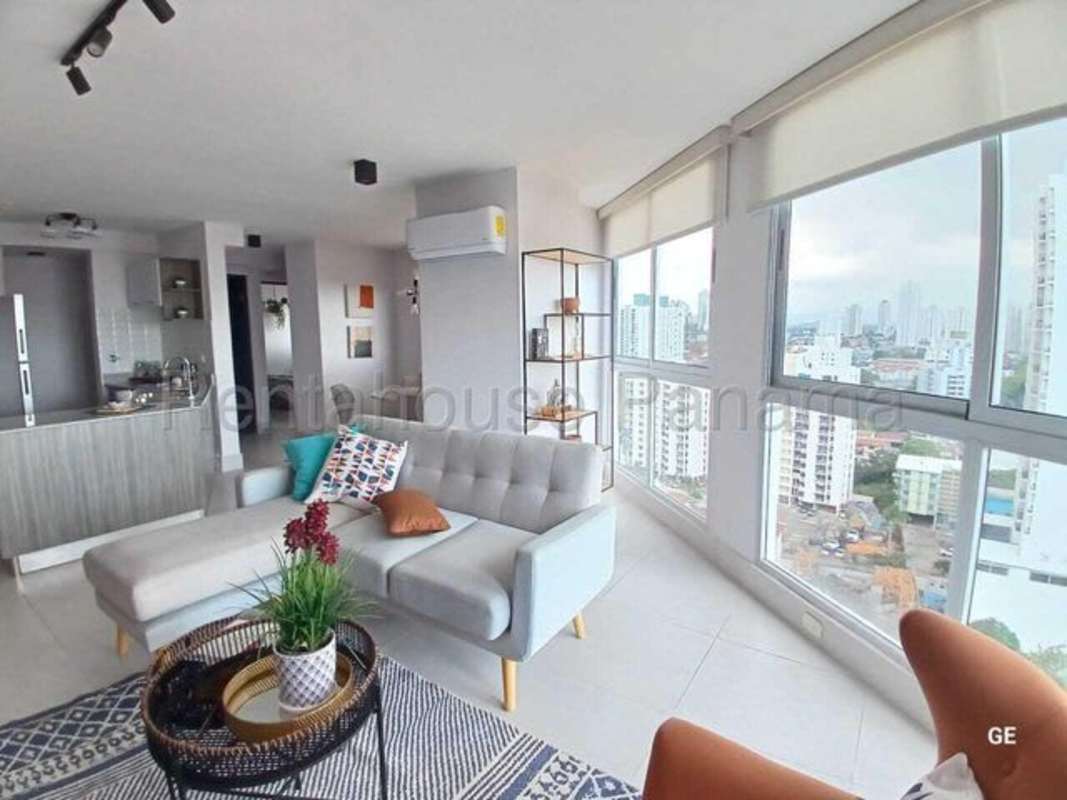 Living room with large windows open kitchen city view PH Park Oasis Panama