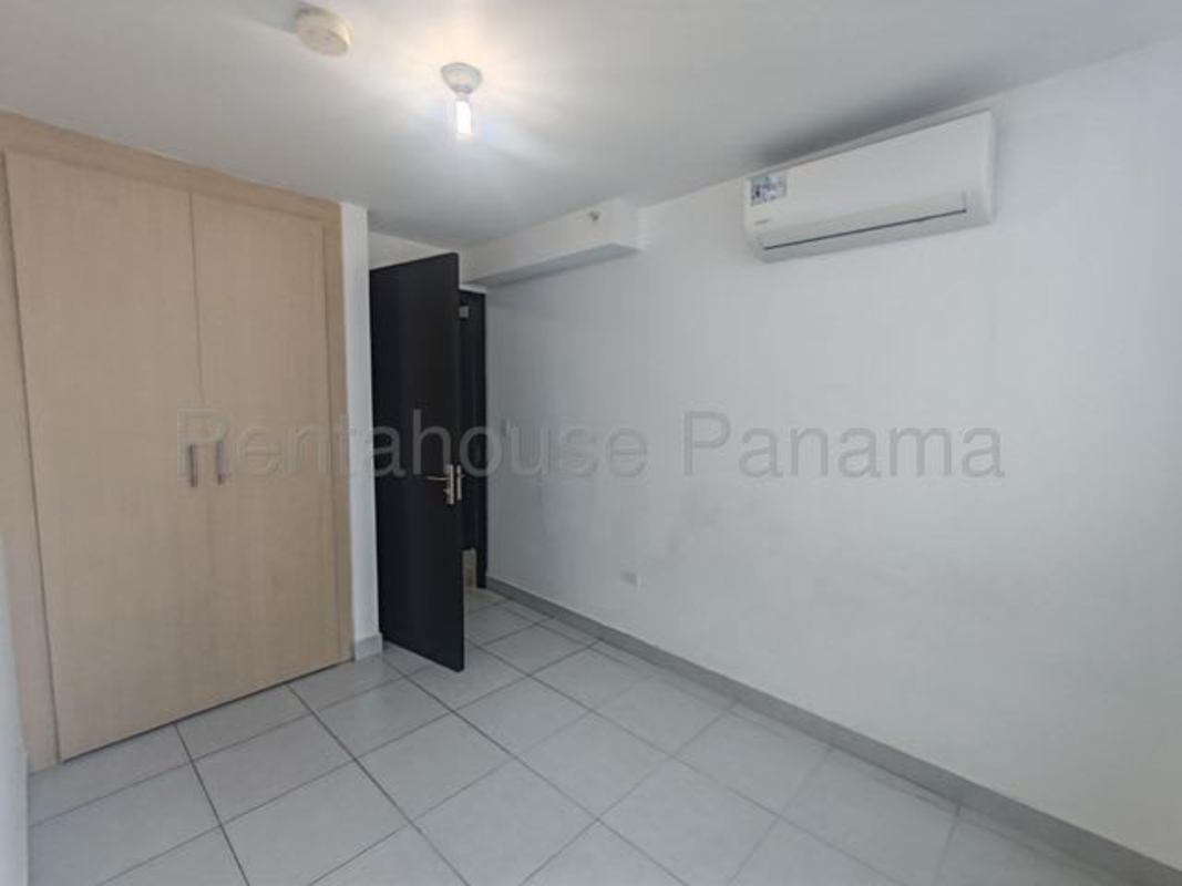 Bedroom space with light tile floor, closet area, and AC hookup PH Carrasquilla Plaza