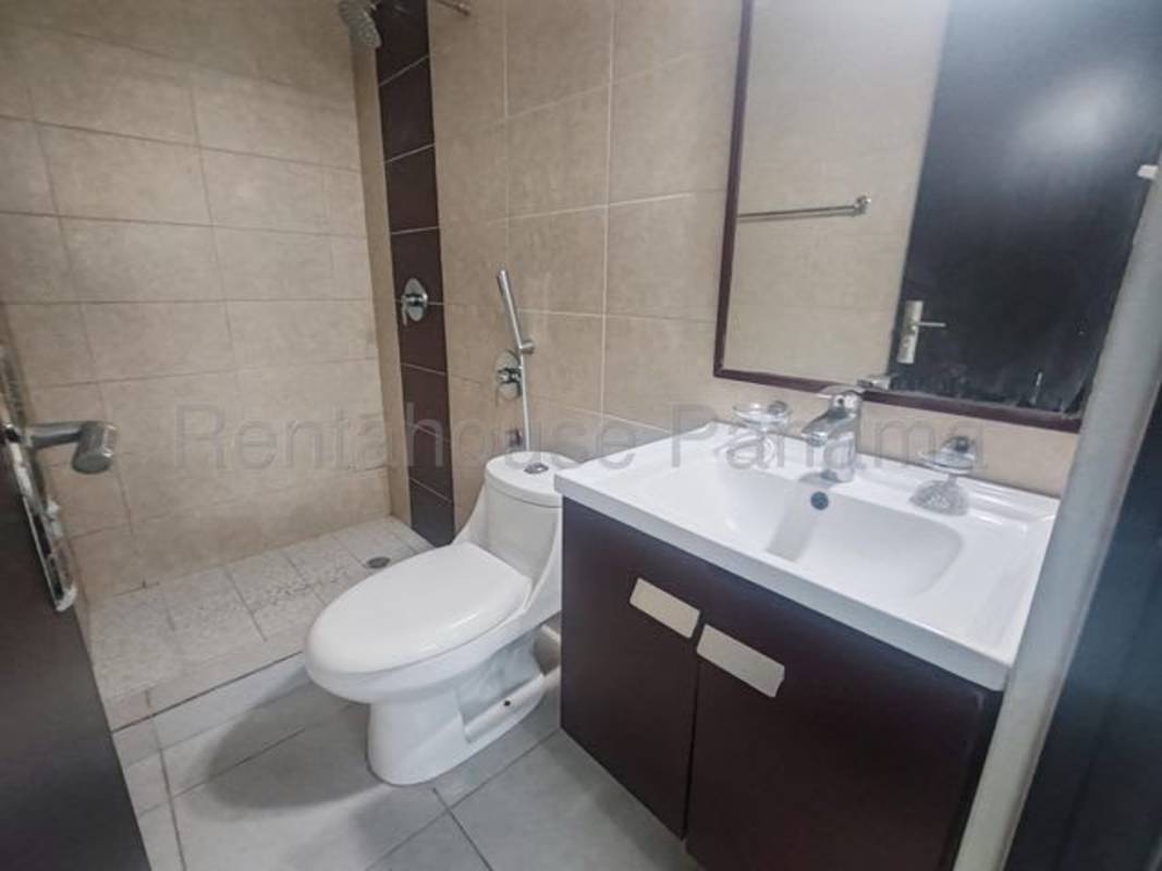 Bright bathroom with modern tiles, vanity, and walk-in shower Carrasquilla Plaza
