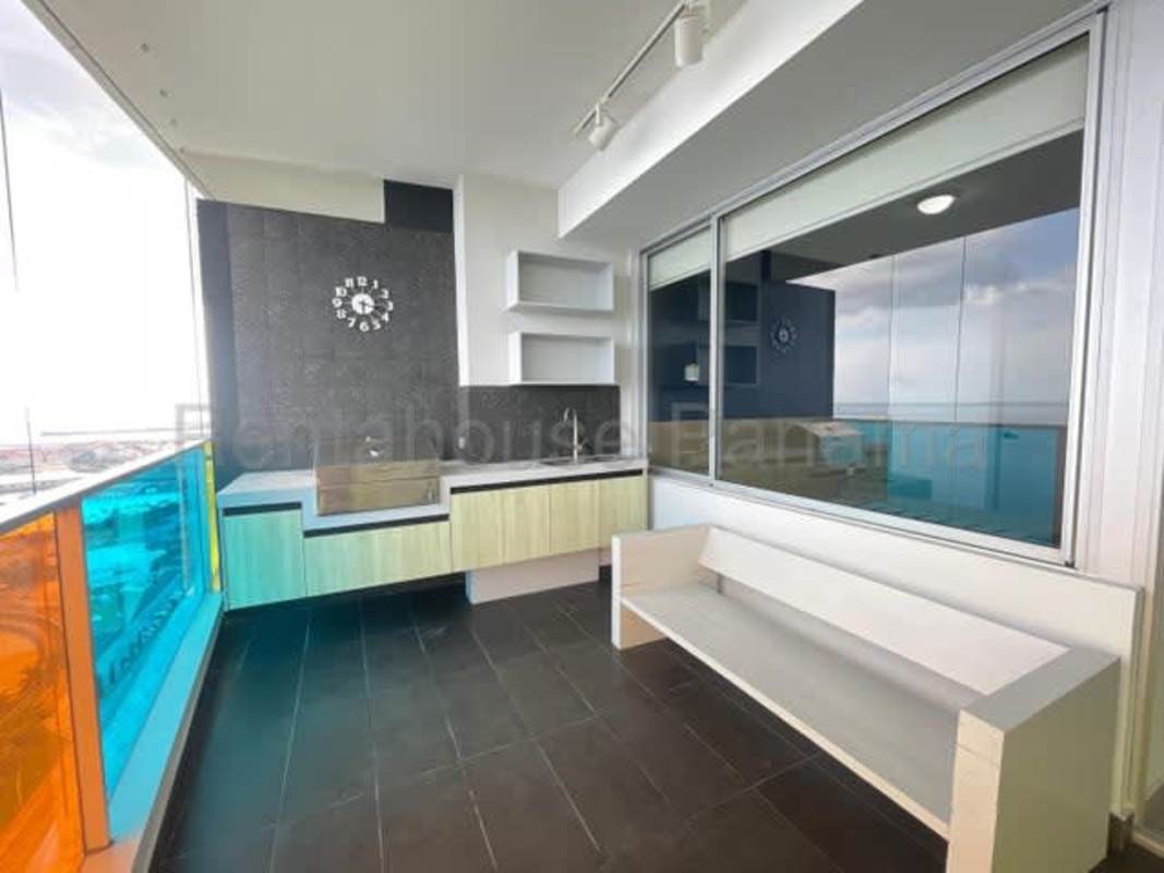 Modern furnished living-dining area with direct ocean view balcony in PH Element Avenida Balboa Panama