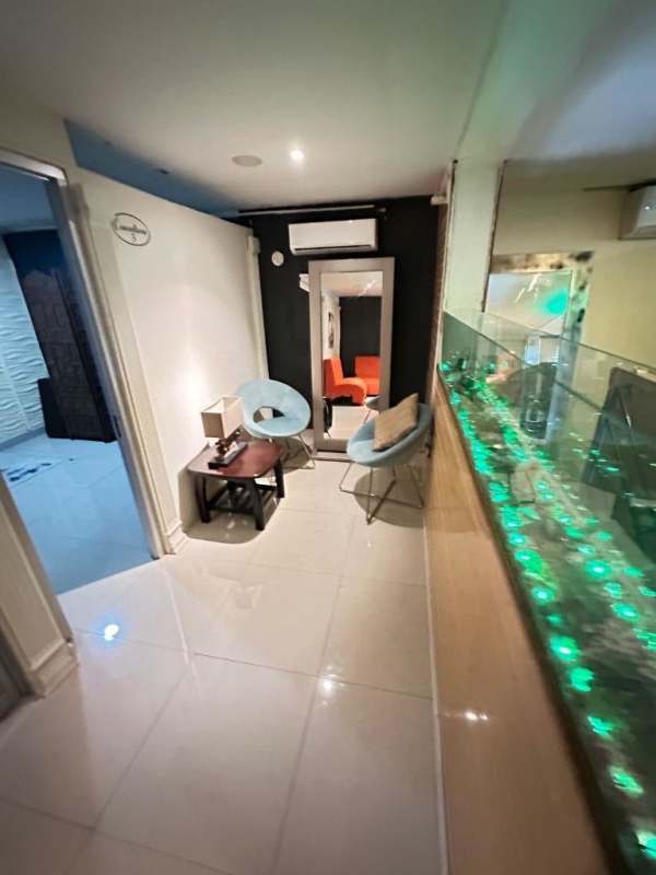 Commercial lounge area with blue chairs, mirror, air conditioning on Via Brasil business locale Panama