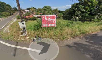 Lot with for sale sign at the corner with street access, utility poles Barrio Balboa La Chorrera Panama