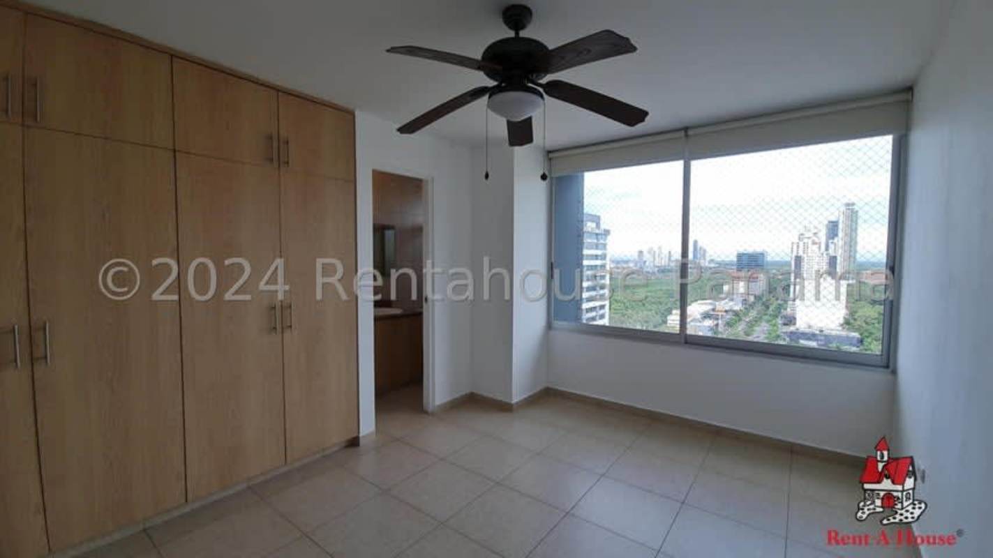 Bedroom with built-in closet, large window with city view in PH Costa del Este Panama