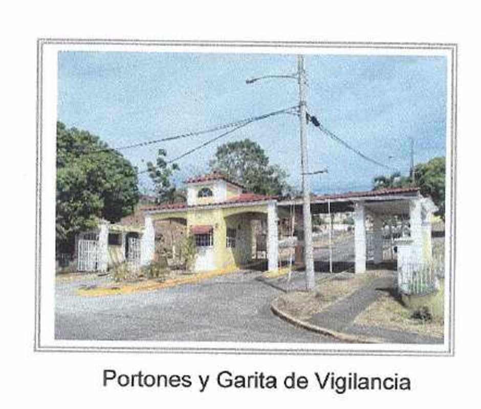 Gated entrance with guardhouse and security booth at Villas de Cerro Lindo Villa Lucre Panama