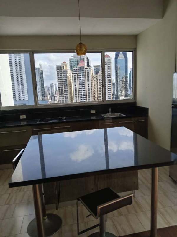 Sleek kitchen design with granite counters and large windows overlooking downtown in PH Denovo Obarrio