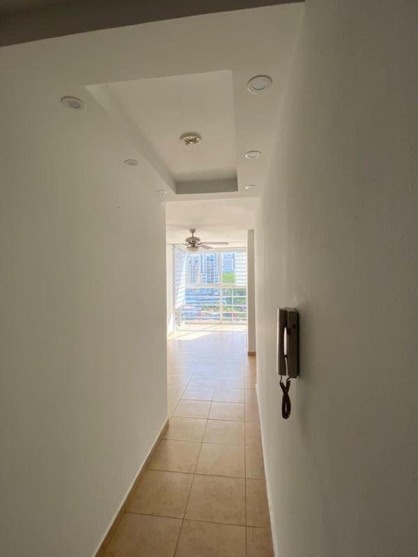 Hallway with recessed lighting opening to bright living room in PH Cosmopolitan Tower Panama