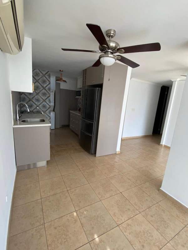 Modern kitchen dining space with ceiling fan, tile floors, cabinets and appliances at PH Cosmopolitan Tower Panama