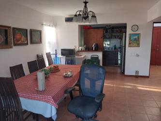 Dining space with tiled floors and open plan connected to kitchen with golf views Decameron Rio Hato