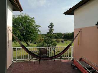 Kitchen with stainless appliances, wood cabinetry, tile backsplash Decameron resort villa Panama