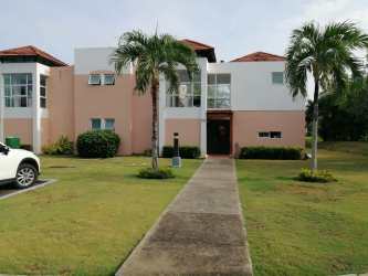 Spacious lawn with tropical landscaping behind villa at Decameron Beach Resort Panama