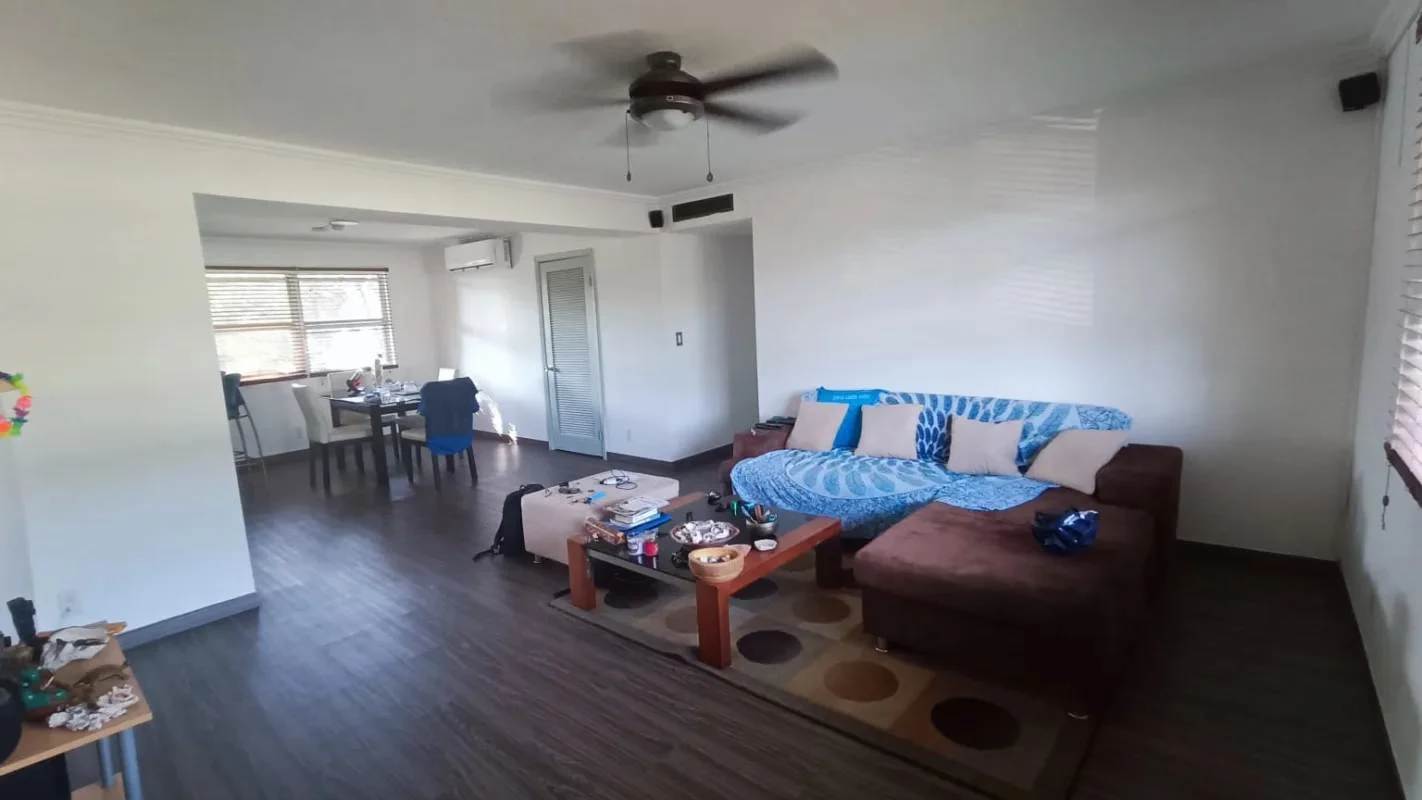 Contemporary open-plan living dining room with large windows and wood floors in Clayton Panama