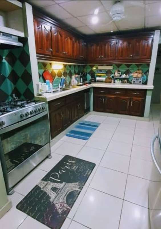 Spacious kitchen with wooden cabinets traditional style in Clayton luxury house Panama