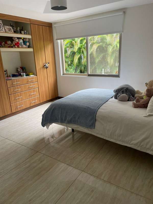 Open-plan living dining with tile floors and large windows at Embassy Gardens Clayton Panama