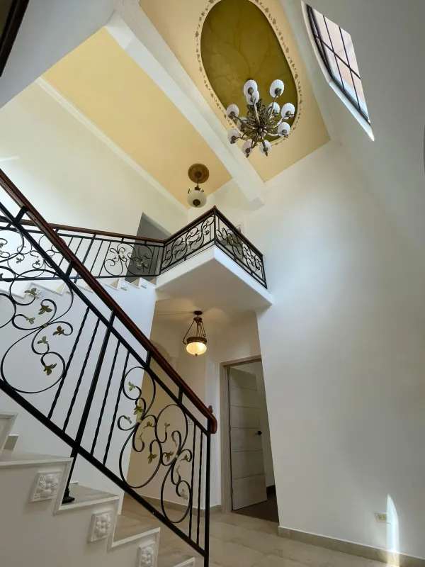 Beautiful Mediterranean style entrance foyer with ornate staircase in Clayton Village house Panama