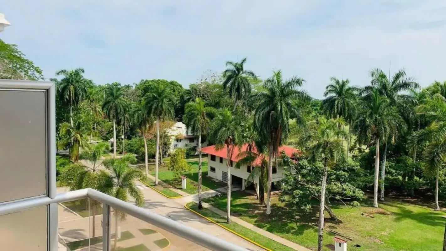 Scenic balcony with tropical landscaping and neighborhood rooftops at PH Canal View Clayton Panama