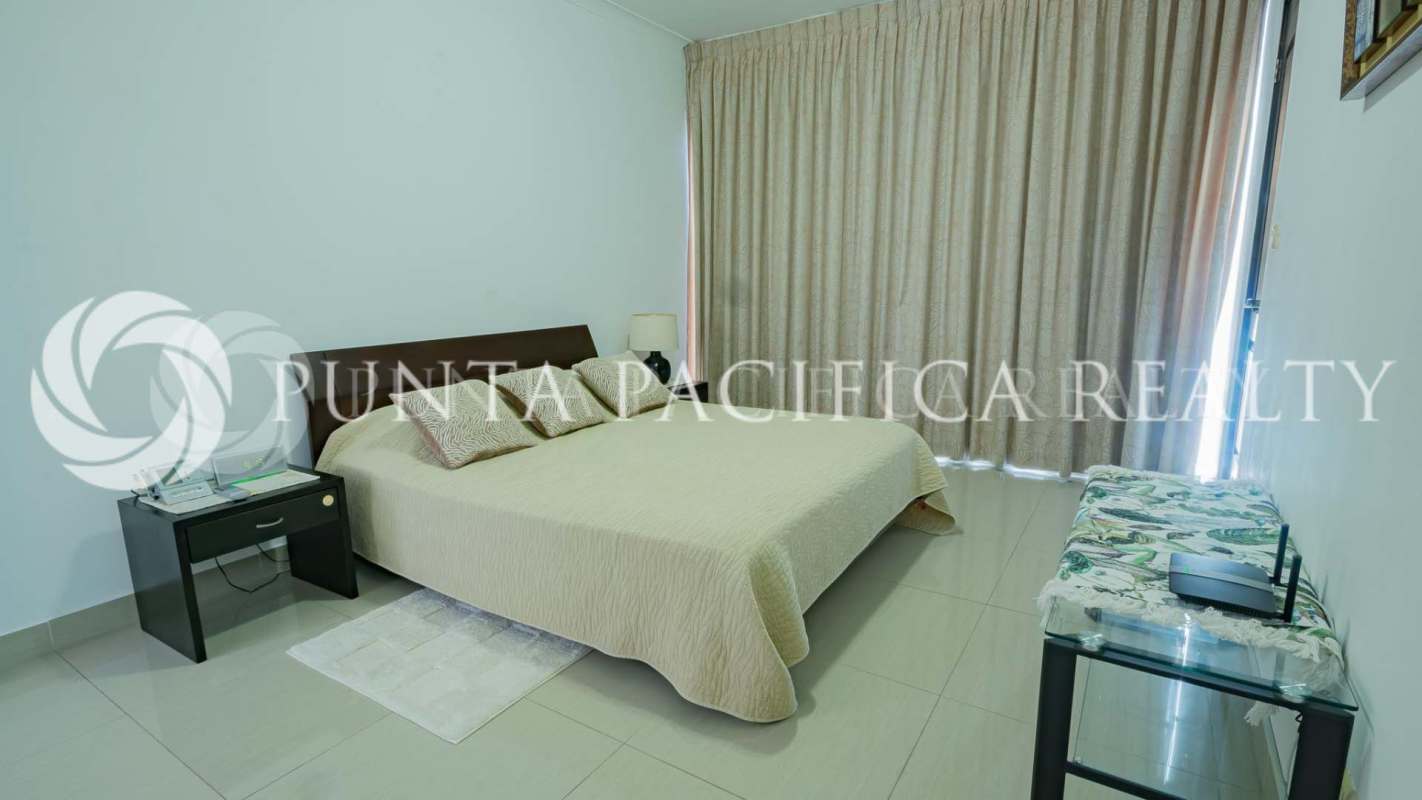 Minimalist bedroom with tile floor, window with curtains, queen bed in PH Pacific Sky Punta Pacífica