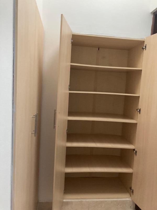 Sunny bedroom with marble floor, large corner windows overlooking Panama skyline at PH Pacific Village