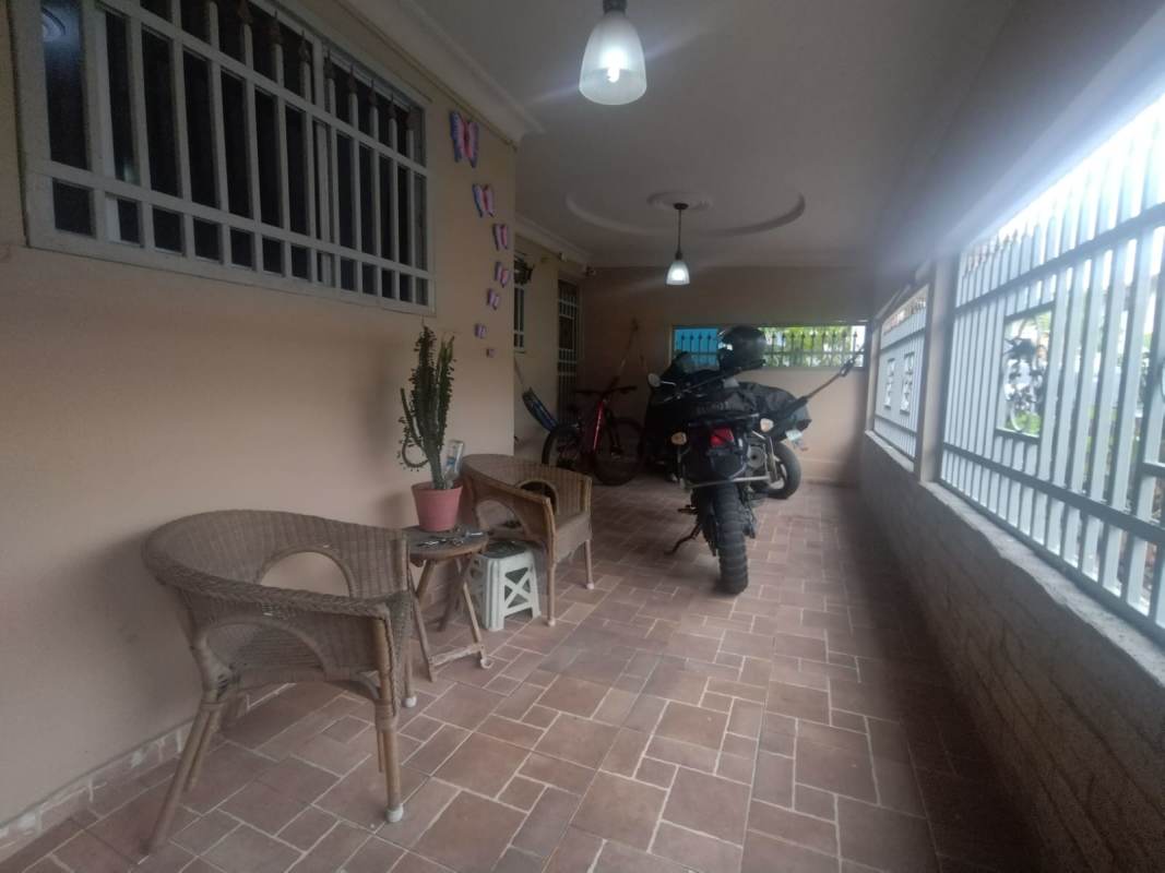 Indoor patio space with tiled floor and windows in Villa Zaita residence