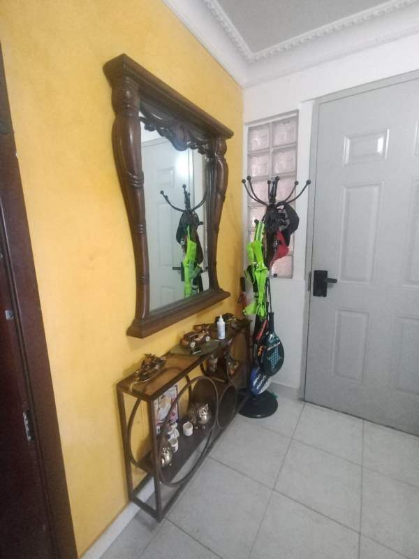 Tile floor hallway with white walls and yellow accent wall Villa Zaita house