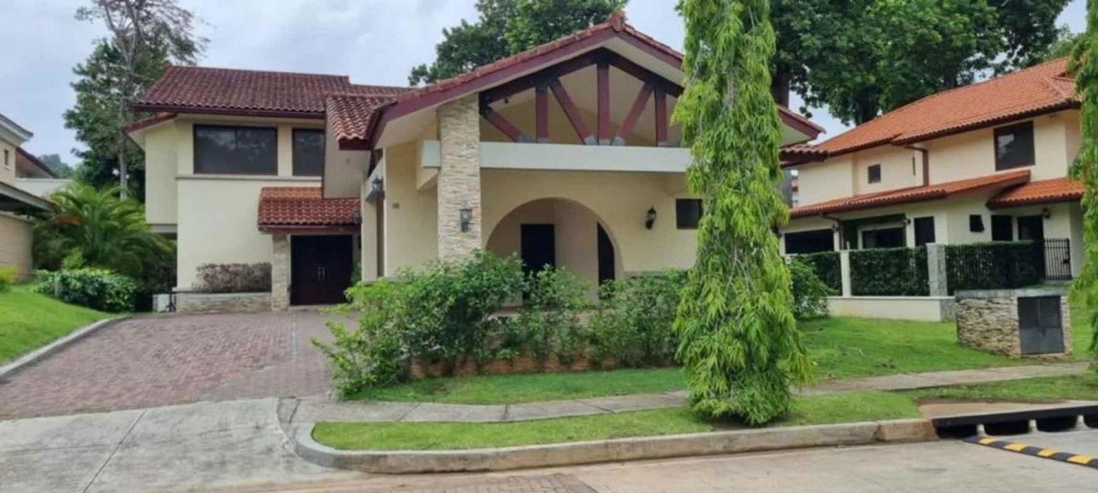 Front facade of two-story Mediterranean home with driveway and landscaping in Clayton