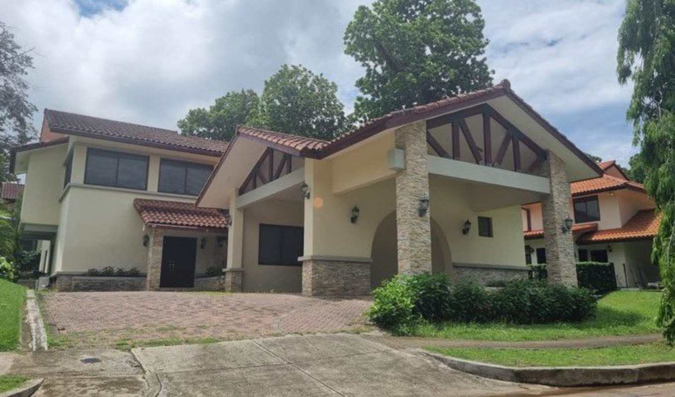 Two-story house with red tile roof and landscaped garden in Clayton Panama for rent