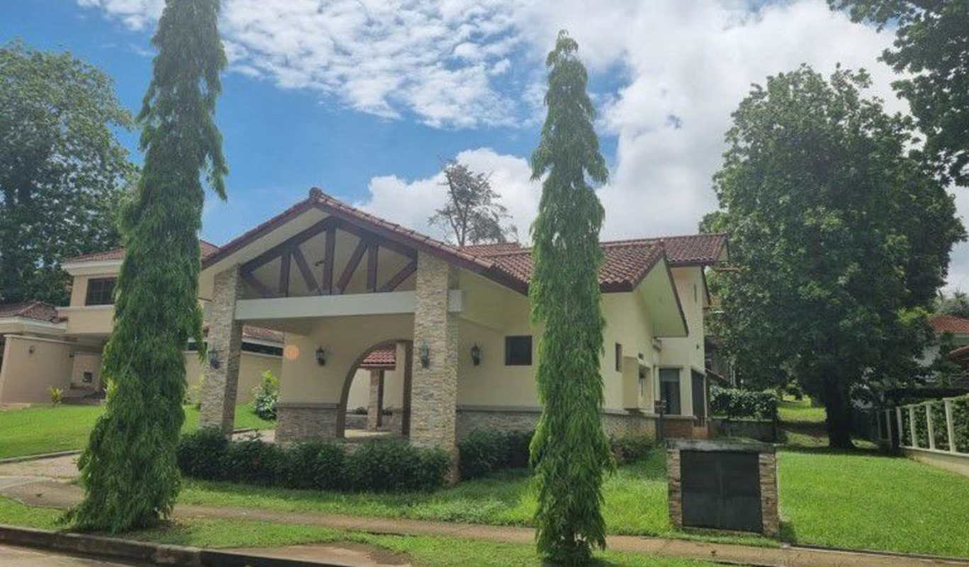 Two-story house with stone columns, red tile roof, landscaped yard in Clayton Panama rental home