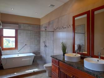 Single-story Mediterranean colonial home in Santa Lucia Boquete with tile roof and garden