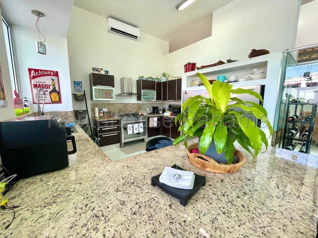 Modern kitchen with granite countertops, stainless steel appliances and breakfast area in Altos del Golf luxury house