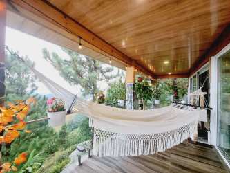 Contemporary kitchen with pendant lights in mountain cabin Altos del María Panama