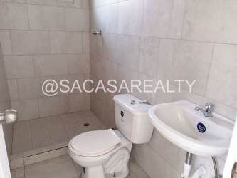 Minimalist bathroom with shower sink toilet in Vista Alegre house Panama