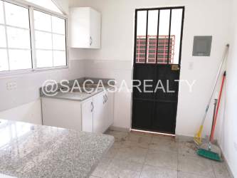 Compact kitchen with granite countertop stainless sink black door in house Vista Alegre Arraijan Panama
