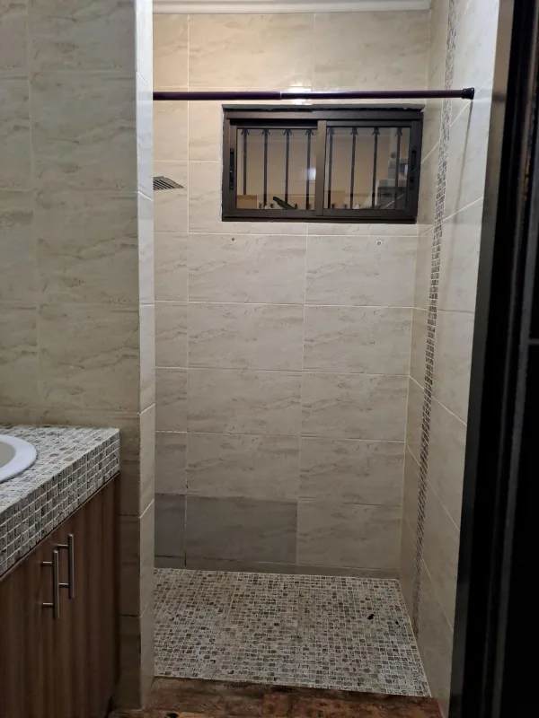 Large open living dining area with wood-like flooring and neutral walls in Villa de las Fuentes home