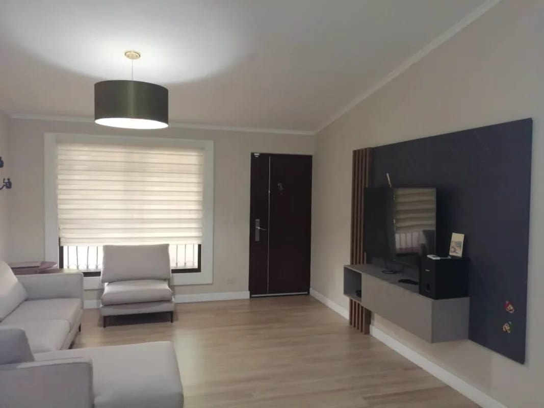 Kitchen with wood cabinets, mosaic backsplash, gas stove, and modern appliances Panama City