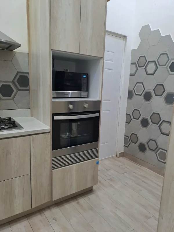 Modern bathroom with walk-in shower, mosaic countertop and framed mirror Panama