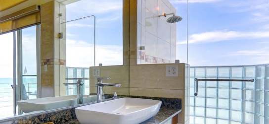 Living room with floor to ceiling windows ocean views modern furnishings Casa Caracol Playa Corona