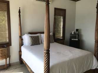 Infinity swimming pool with oceanfront palapas and sandy beach Casa Caracol Playa Corona Panama