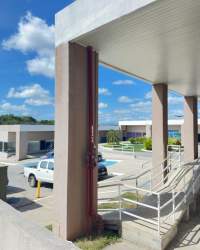 Ramp and walkway in front of commercial space with parking area at Mystic City La Chorrera
