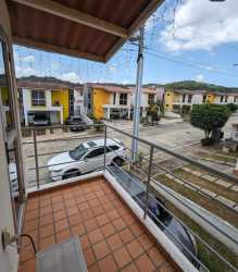 Private balcony with tiled floor overlooking quiet suburban street and houses in Arraiján Panama