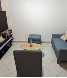Dining area with blue wall, air conditioner, six chairs and modern decor in duplex Santillana Arraiján