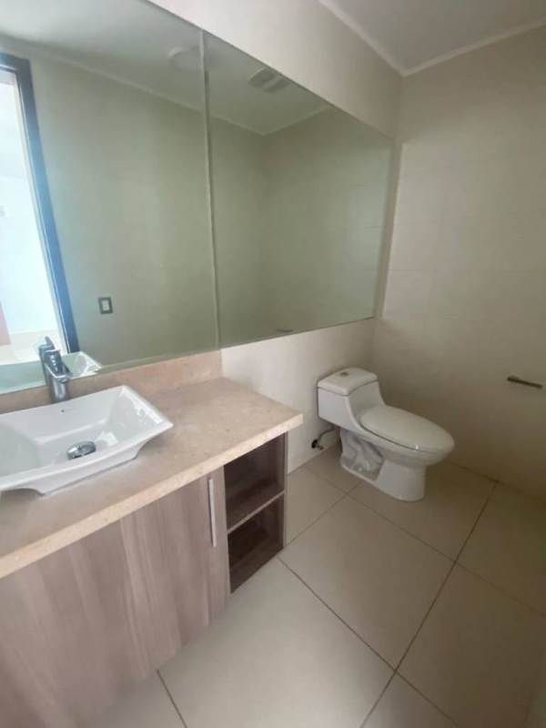 Apartment kitchen with L-shape layout, gas cooktop, oven, range hood modern cabinetry PH Bali Costa del Este Panama