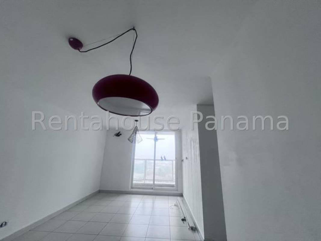 Spacious living room with tiled floor and large window at PH Cantabria II apartment Panama City