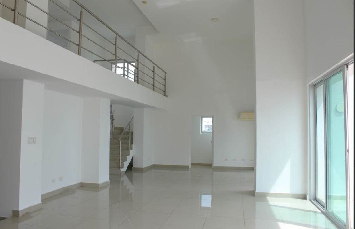 Open mezzanine overlooking living room with metal railings in duplex loft for rent Parkside Costa del Este