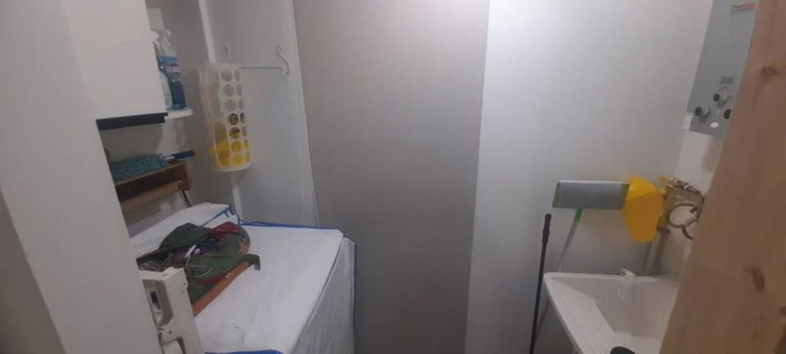 Laundry utility room with sink, shelves, washer and water heater in Panama apartment