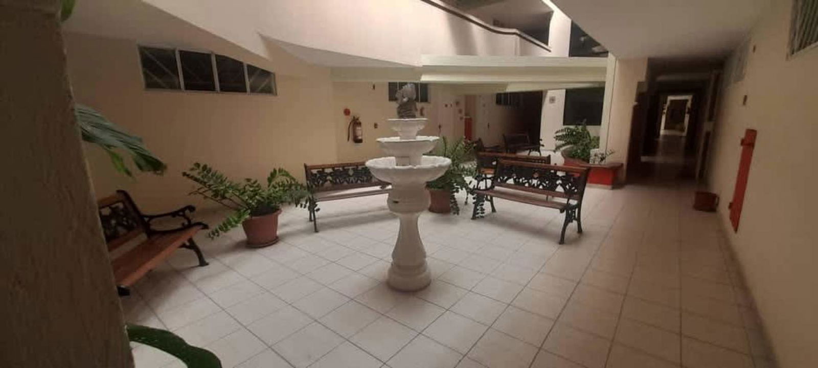 Compact kitchen with stainless refrigerator, gas stove, upper cabinets in Parque Lefevre Panama