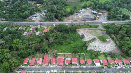 Kitchen with wooden cabinets, granite style counter, tiled walls in Bugaba house Panama
