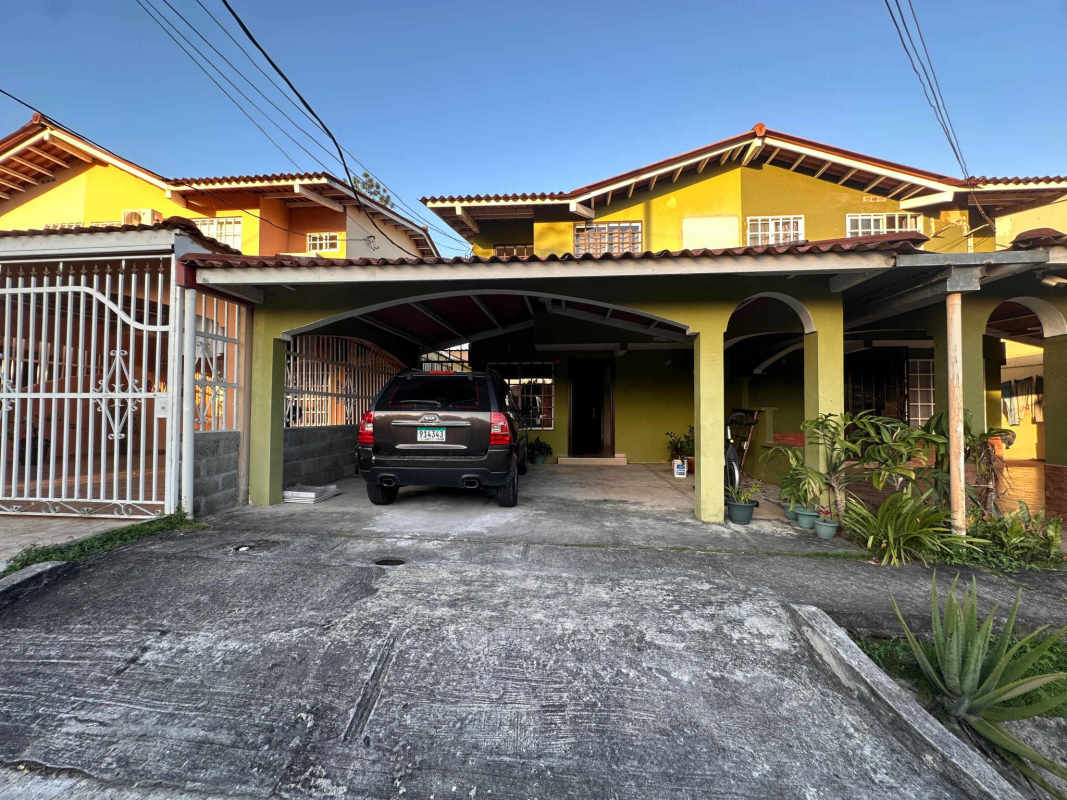 Kitchen area with tile flooring, refrigerator, black cabinets in Villa Eva duplex Las Cumbres Panama