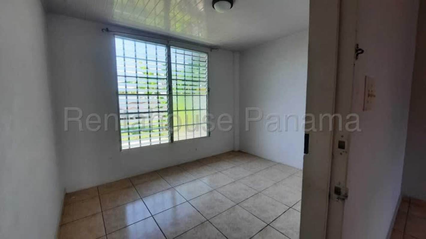 Covered backyard terrace overlooking fenced garden Las Terrazas Brisas del Golf Panama