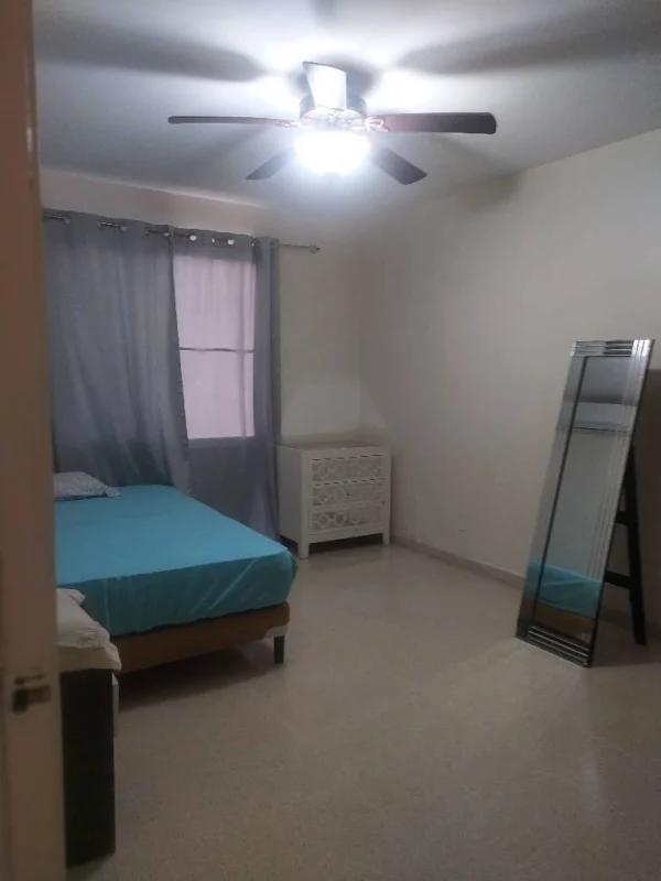 Bedroom with blue accents ceiling fan gray curtains PH Del Rey El Cangrejo