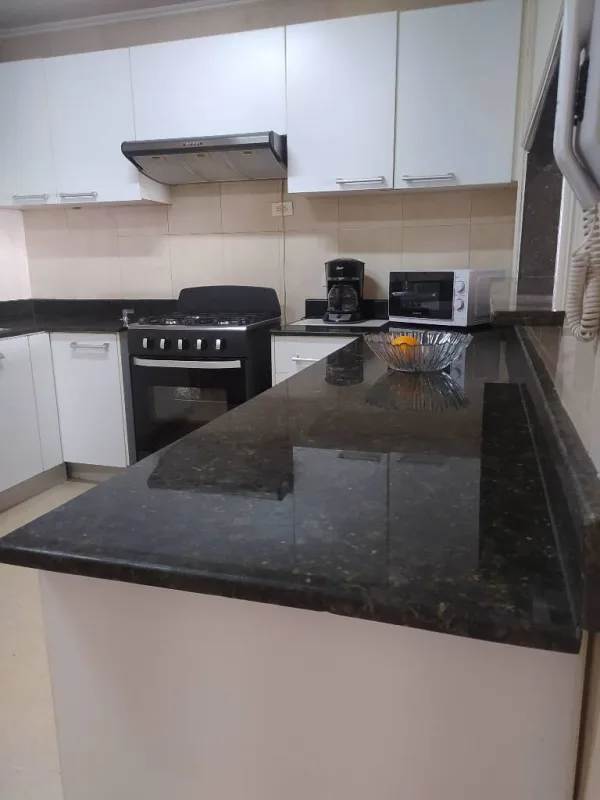 Kitchen with granite counters gas stove white cabinets PH Del Rey El Cangrejo
